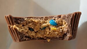 Reese's Spring Sprinkles Big Cup with a bite showing colorful crunchy sprinkle candies inside
